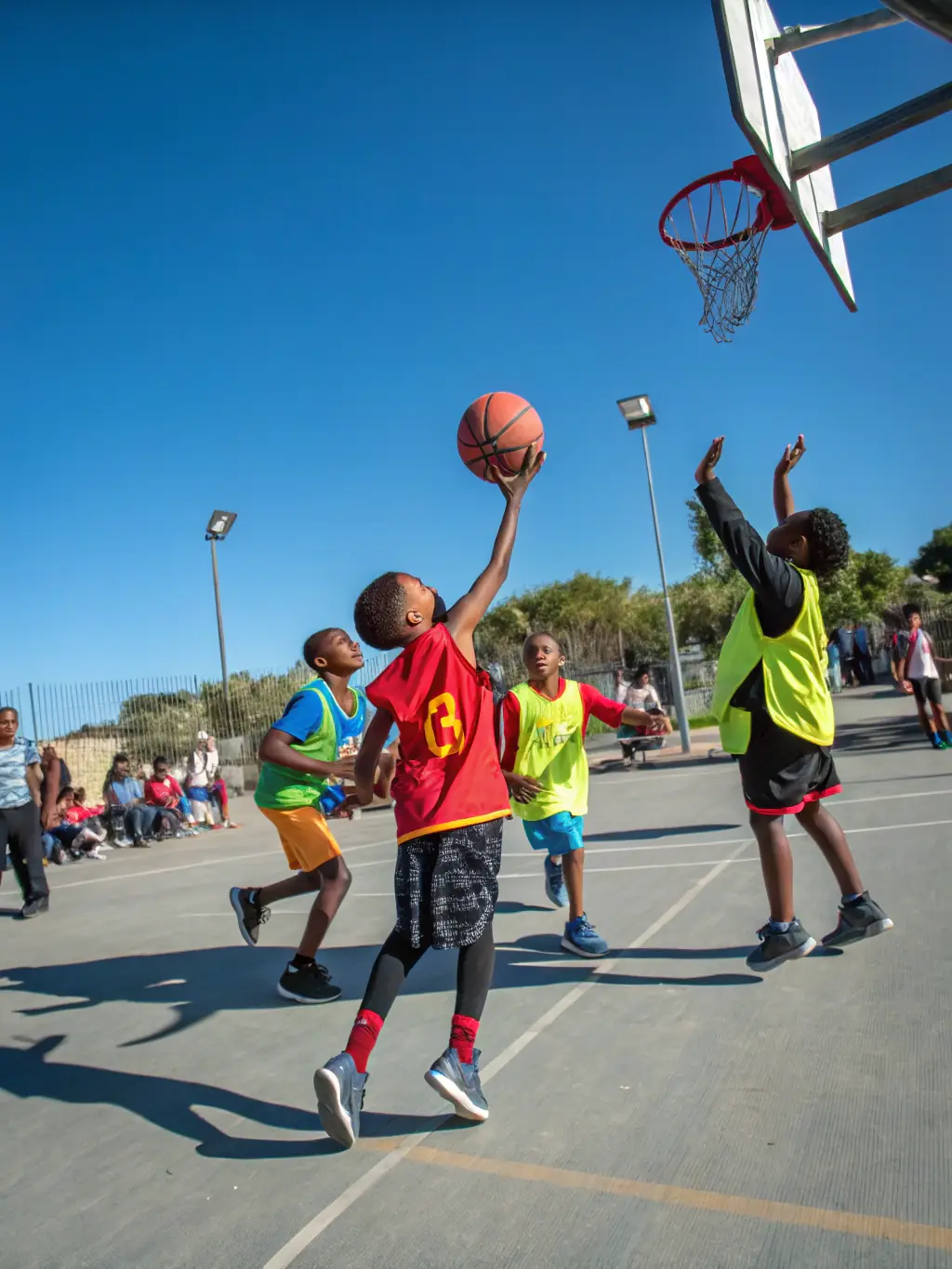 A diverse group of children participating in a VALECHEL BASKET BALL recreational activity, highlighting inclusivity and community engagement.